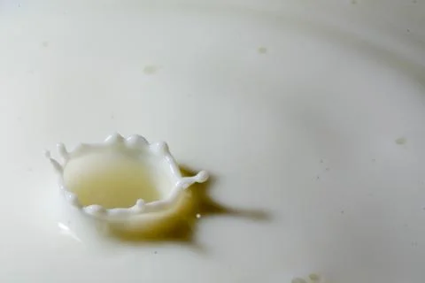 Liquid milk drop falling Stock Photos
