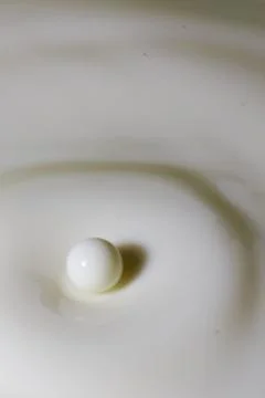 Liquid milk drop falling Stock Photos