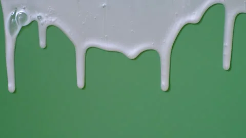 Liquid moisturizing shampoo dripping down on green background close-up. Stock Footage 319274756