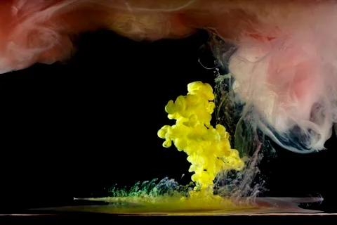 Liquid multi-colored paint mixed moving in water Stock Photos