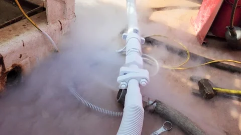 Liquid nitrogen is flowing in rigid pipeline during transfer process. Stock Footage 308179900