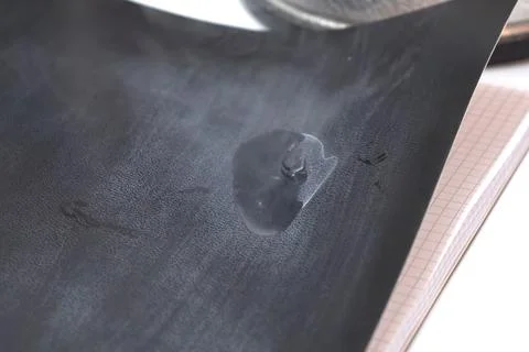 Liquid nitrogen on notebook paper. Stock Photos