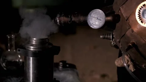 Liquid nitrogen is poured into a thermos from a Dewar vessel. Steam comes out Stock Footage 168260834