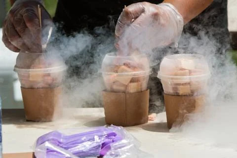 Liquid Nitrogen Steams As Man Prepares Frozen Treats At Festival Stock Photos