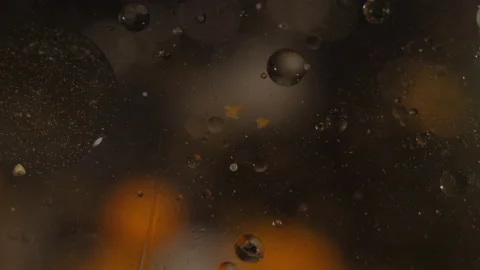 Liquid orange and black bubbling orbs motion background texture Video stock 130985801