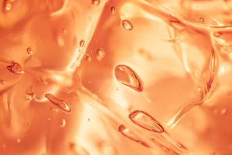 Liquid orange gold serum hyaluronic acid gel drops close-up Stock Photos