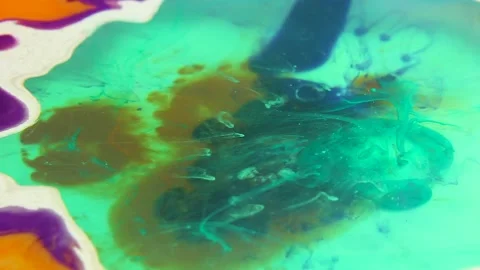 Liquid paint mixing artwork with splash and swirl Stock Footage 165144409