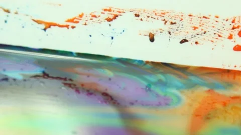 Liquid paint mixing artwork with splash and swirl Video stock 165185018