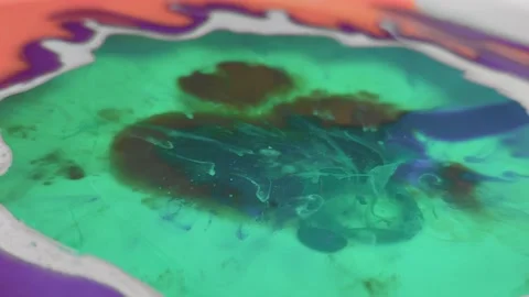 Liquid paint mixing artwork with splash and swirl Video stock 165352289