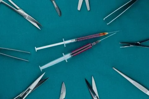 Liquid parenteral products in syringe with basic surgical instrument Stock Photos