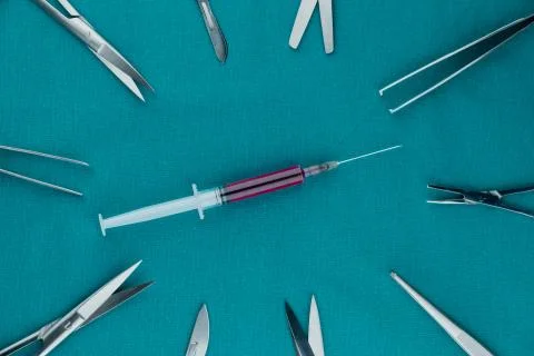 Liquid parenteral products in syringe with basic surgical instrument Stock Photos
