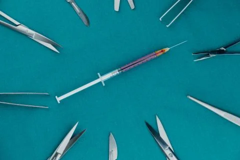 Liquid parenteral products in syringe with basic surgical instrument Stock Photos