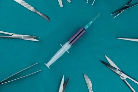 Liquid parenteral products in syringe with basic surgical instrument Stock Photos