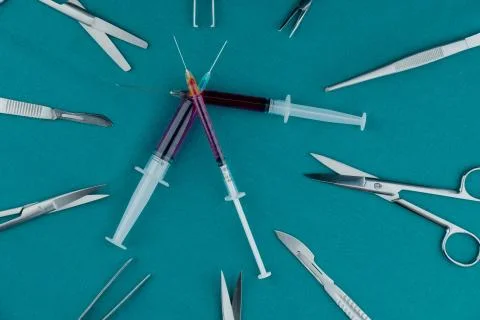 Liquid parenteral products in syringe with basic surgical instrument Фото