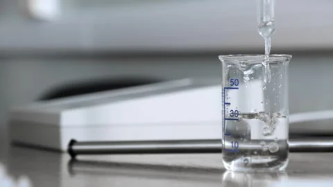 The liquid is poured into a measuring cup. Stock Footage 281701670