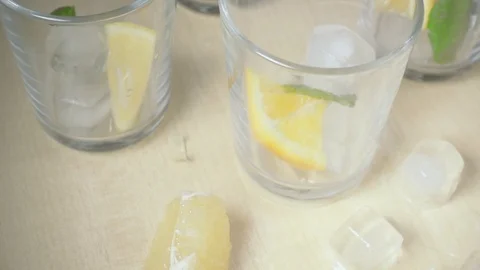 The liquid pours into the glass on the table slow motion Stock Footage 87699467
