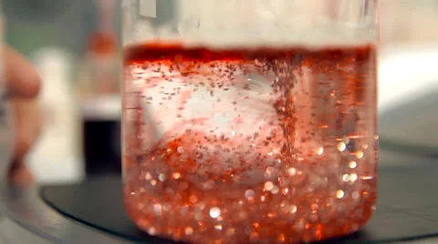 Liquid red stuff with glowing particles is flowing Stock Footage 59108827