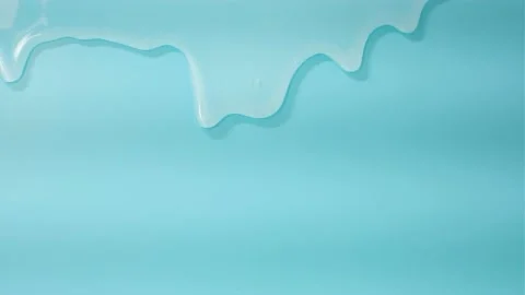 Liquid shampoo dripping down on blue background close-up. Stock Footage 214211935