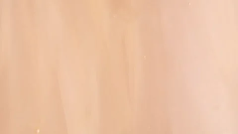 Liquid shiny cosmetics product with bubbles in peach fuzz colour, macro, to.. Stock Footage 258917125