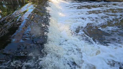 Liquid Silk: 4K Slow Motion of Water Cascading Over a River Weir in Jupiter Stock Footage 330658394