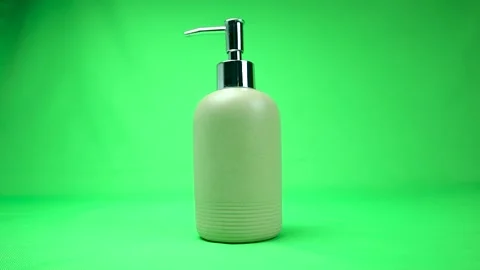 Liquid soap in an opaque bottle on a green background. Chromakey. Stock Footage 145617922