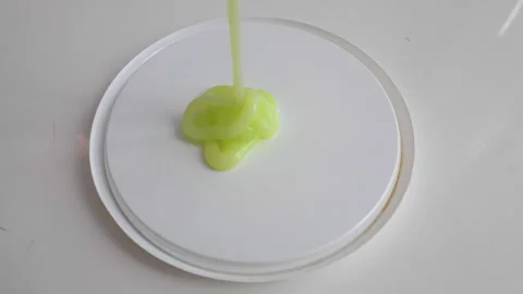 Liquid soap is pouring, liquid paint is light green. Slow motion Stock Footage 336557006