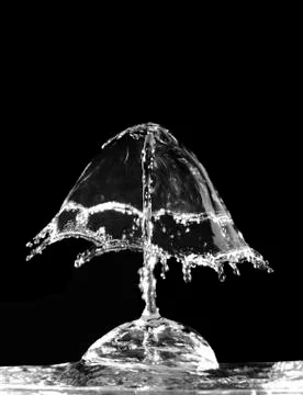 Liquid splash on black background Stock Photos