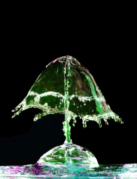 Liquid splash on black background Stock Photos