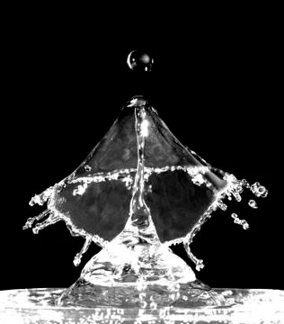 Liquid splash isolated on black background Stock Photos