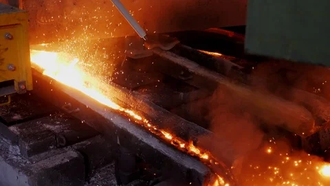 The liquid steel flows through the discharge chute. Steel production . Stock Footage 122496048