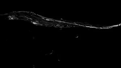 Liquid suface line between underwater and above water with black background. Stock Photos