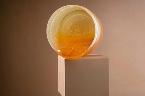 Liquid sugar wax flowing down from jar Stock Photos