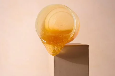 Liquid sugar wax flowing down from jar Stock Photos