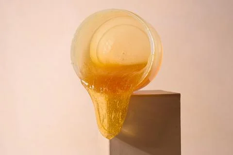 Liquid sugar wax flowing down from jar Stock Photos