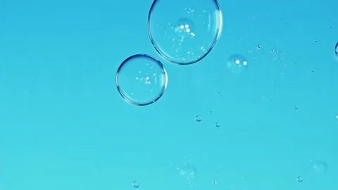 Liquid texture with burst drops on light blue background. Gel cosmetic with Stock Footage 197409601