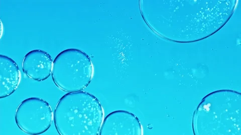 Liquid texture with burst drops on light blue background. Gel cosmetic with Stock Footage 228766440