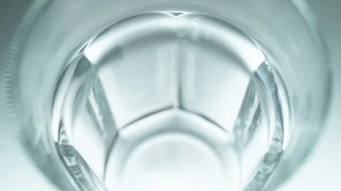 Liquid/Ice falling into a glass in slow motion. Stock Footage 115881350