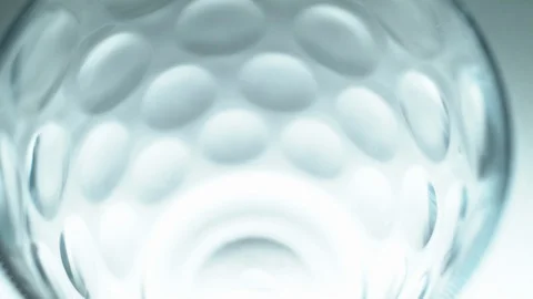 Liquid/Ice falling into a glass in slow motion. Stock Footage 115881485