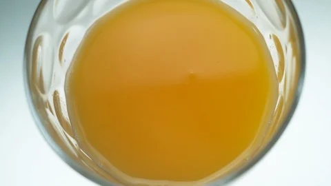 Liquid/Ice falling into a glass in slow motion. Stock Footage 115884545
