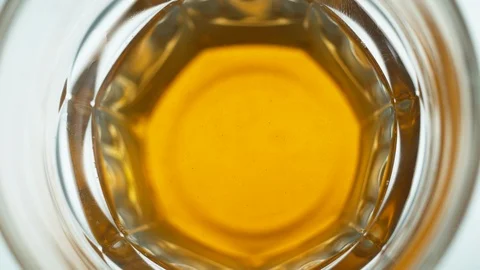 Liquid/Ice falling into a glass in slow motion. Stock Footage 115885235