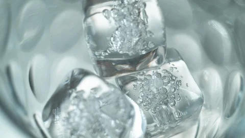 Liquid/Ice falling into a glass in slow motion. Stock Footage 115885796
