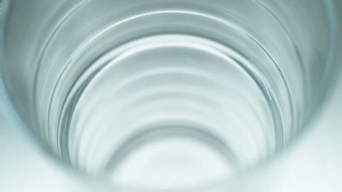Liquid/Ice falling into a glass in slow motion. Stock Footage 115886122