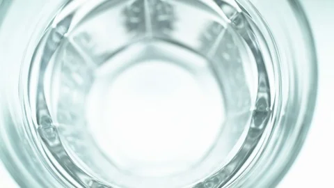 Liquid/Ice falling into a glass in slow motion. Stock Footage 115889264