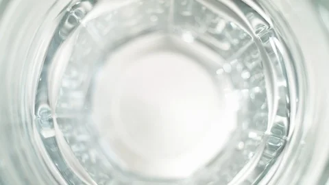 Liquid/Ice falling into a glass in slow motion. Stock Footage 115908445