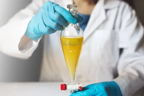 Liquidliquid extraction in laboratory using separatory funnel Stock Photos