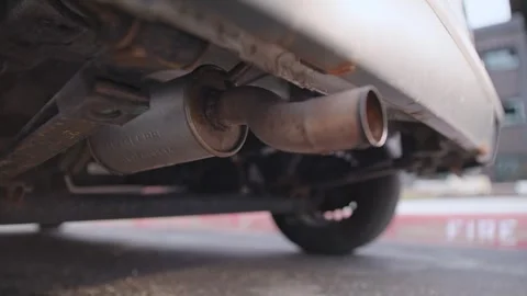 Liquids and steam smoke launch out of rustic van engine at start up Stock Footage 342840633