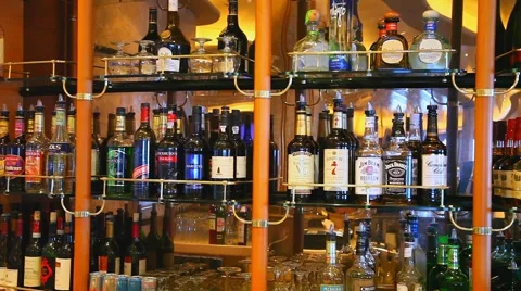 Liquor alcohol bottles displayed on shelves at the bar Stock Footage