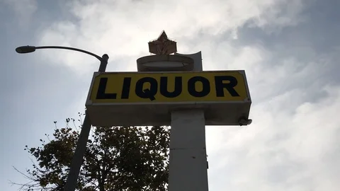 Liquor Sign &amp; Clouds Stock Footage 97968192