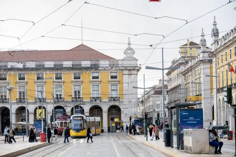 Lisbon Praca do Comercio with modern tram and pedestrians Stock Photos