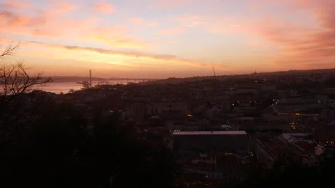 Lisbon sunset timelapse showing Baixa district and 25 April Bridge, Portugal Stock Footage 168236395